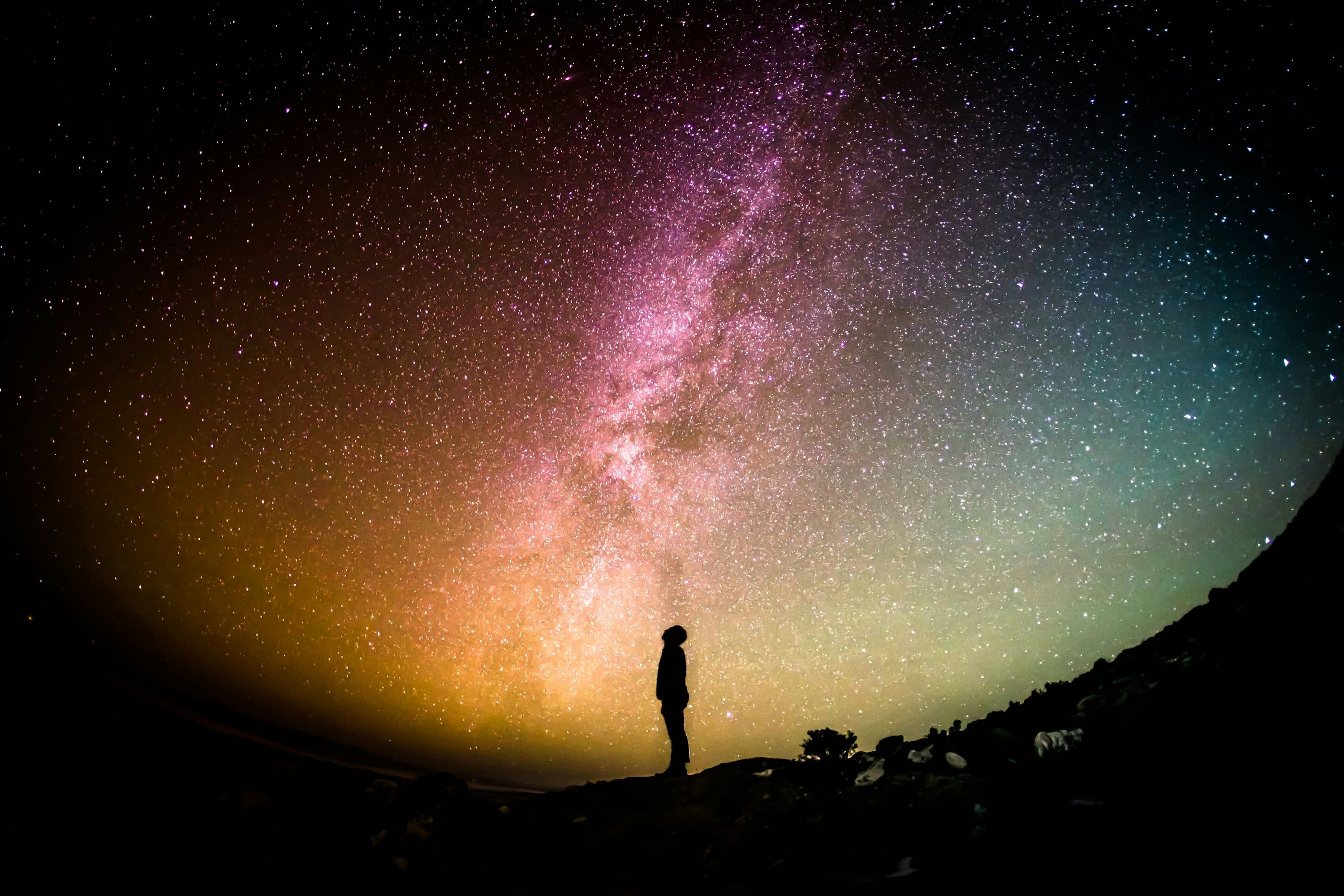 A person gazing at a vibrant galaxy, representing the universe of immersive content on Palace.